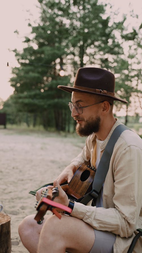 A Man Singing while Playing Guitar