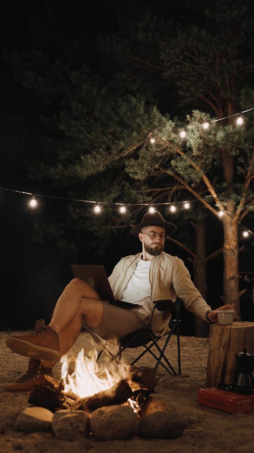 Man Sitting Near a Campfire