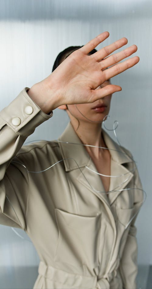 Woman Covering Her Face with Her Hand