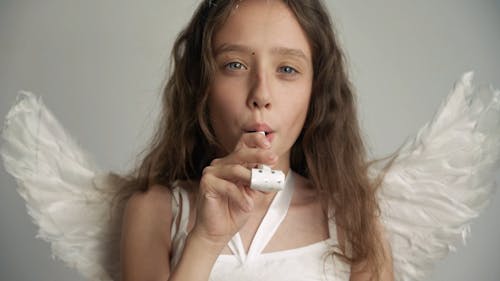 Kid Blowing a Party Whistle