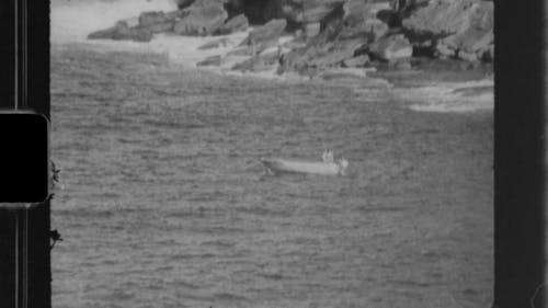 Black and White Footage of a Person Riding on a Boat in the Middle of the Sea