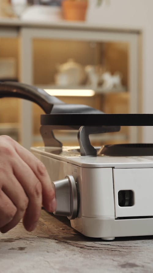 A Person Lighting a Gas Stove