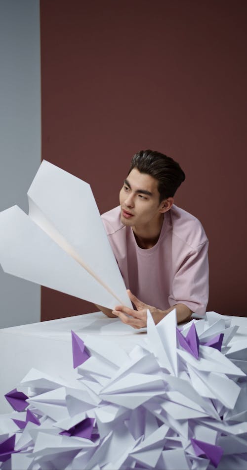 Man holding Paper Plane