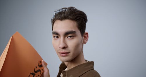 A Man Holding a Big Paper Plane