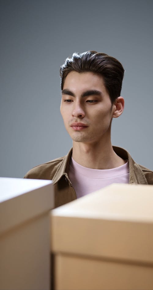 A Man Putting a Paper Plane in a Box