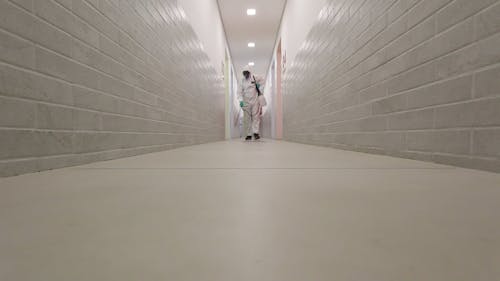 Person Disinfecting Hallway