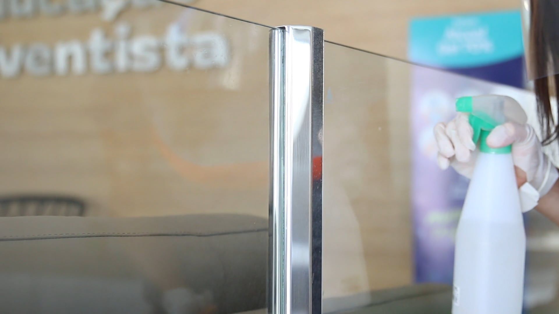 Commercial cleaning technician wiping down a glass surface