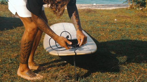 A Man Preparing to Go Surfing