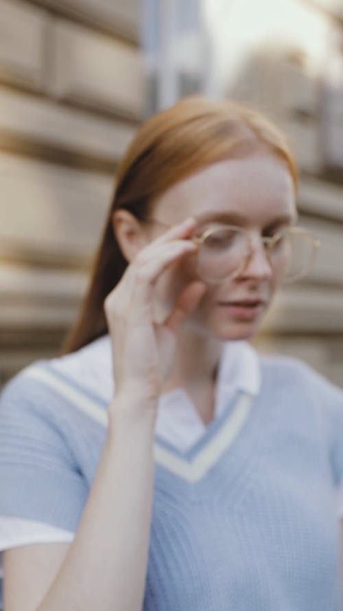 A Woman Taking Off Her Eyeglasses