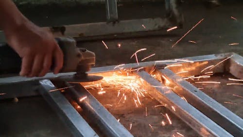 Person Grinding a Metal