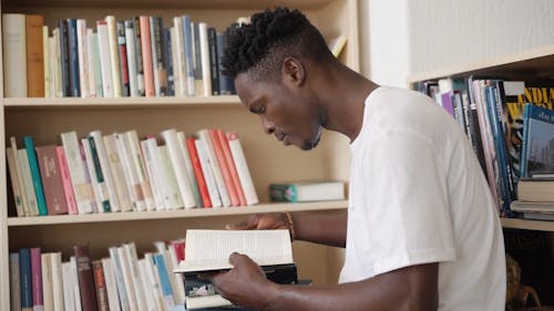 A College Student Reading a Book in the Library