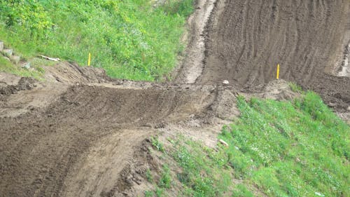 A Person Riding a Motorcycle in a Motocross Track