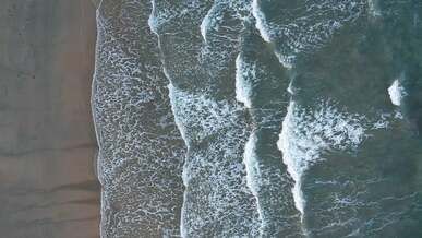 aerial footage of waves crashing on shore