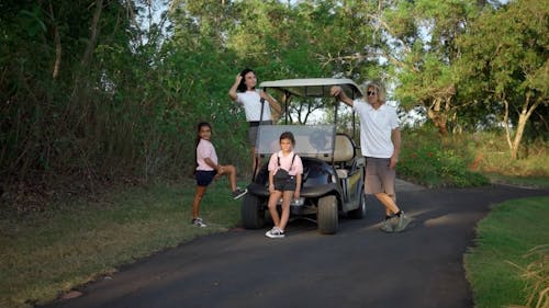 People Standing Beside a Golf Cart
