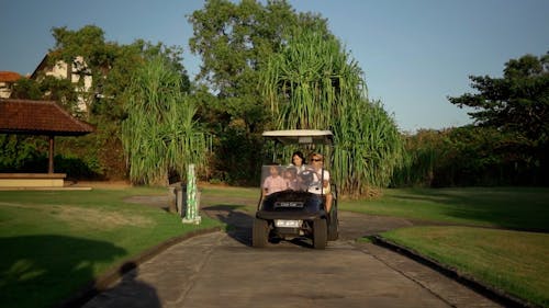 People Riding a Golf Cart