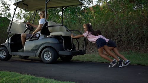 Girls Pushing Golf Cart