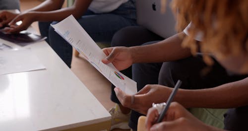 A Man Taking Notes in a Meeting