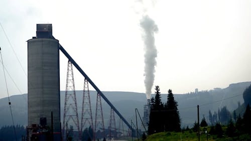 A Factory Chimney Releasing a Black Smoke