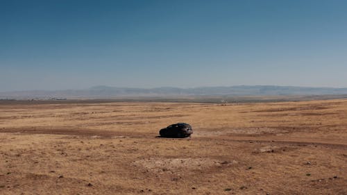 A Car Travelling on a Dirt Road 