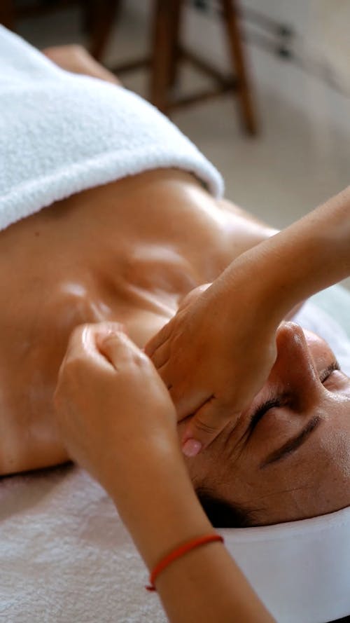 A Woman Having Her Face Massaged