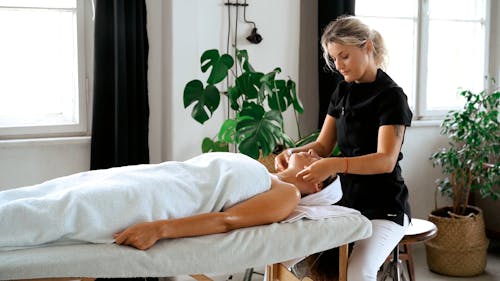 A Therapist Massaging Her Client