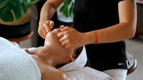 A Woman Relaxing with Face Massage
