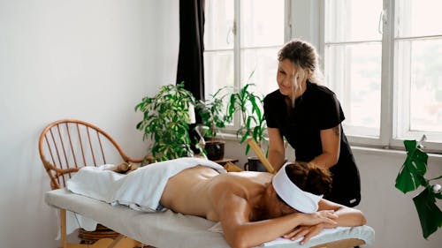 A Therapist Massaging a Client's Back