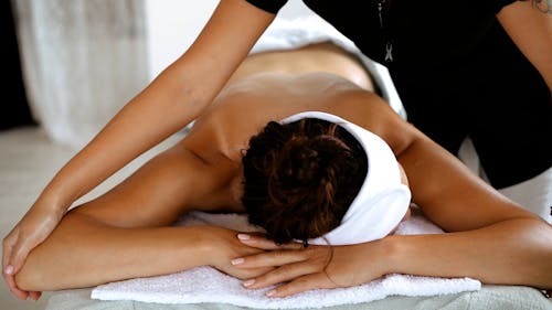 A Massage Therapist Massaging a Client