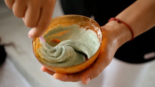 Person Mixing a Facial Mask on a Bowl