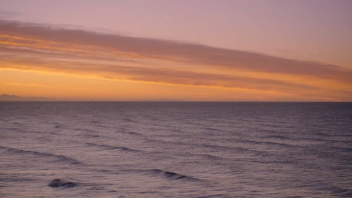 A Video Footage of a Dramatic Sky and a Beach