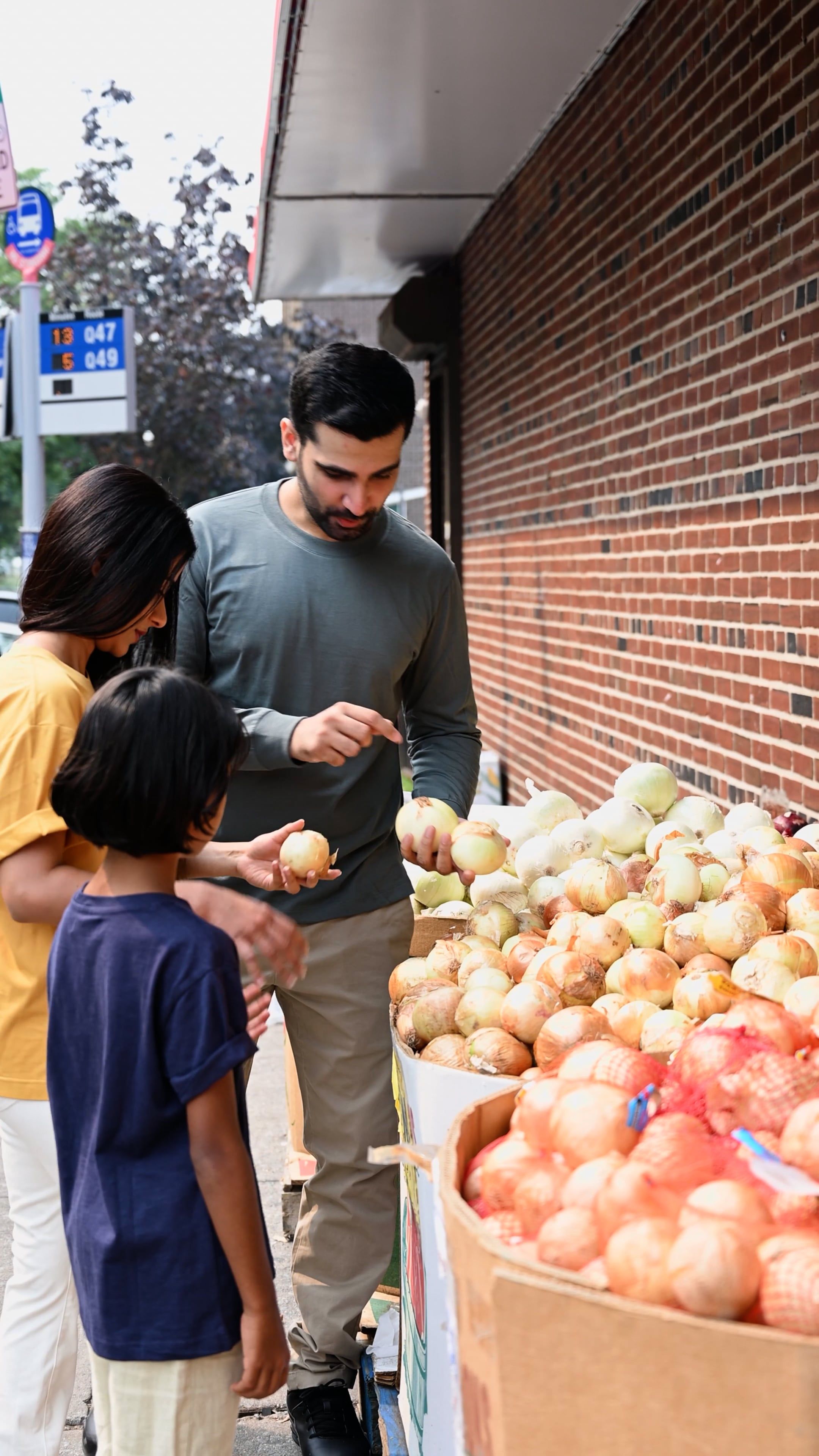 A man and woman are standing in front of a fruit stand Free Stock Video ...