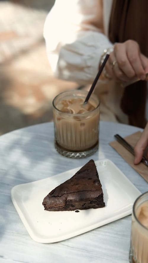 Person Slicing a Cake