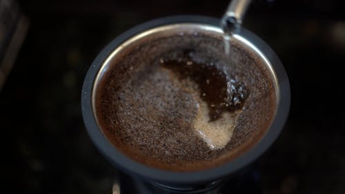 Close Up of Pouring Hot Water in a Coffee 