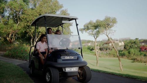 A Happy Family in a Golf Cart