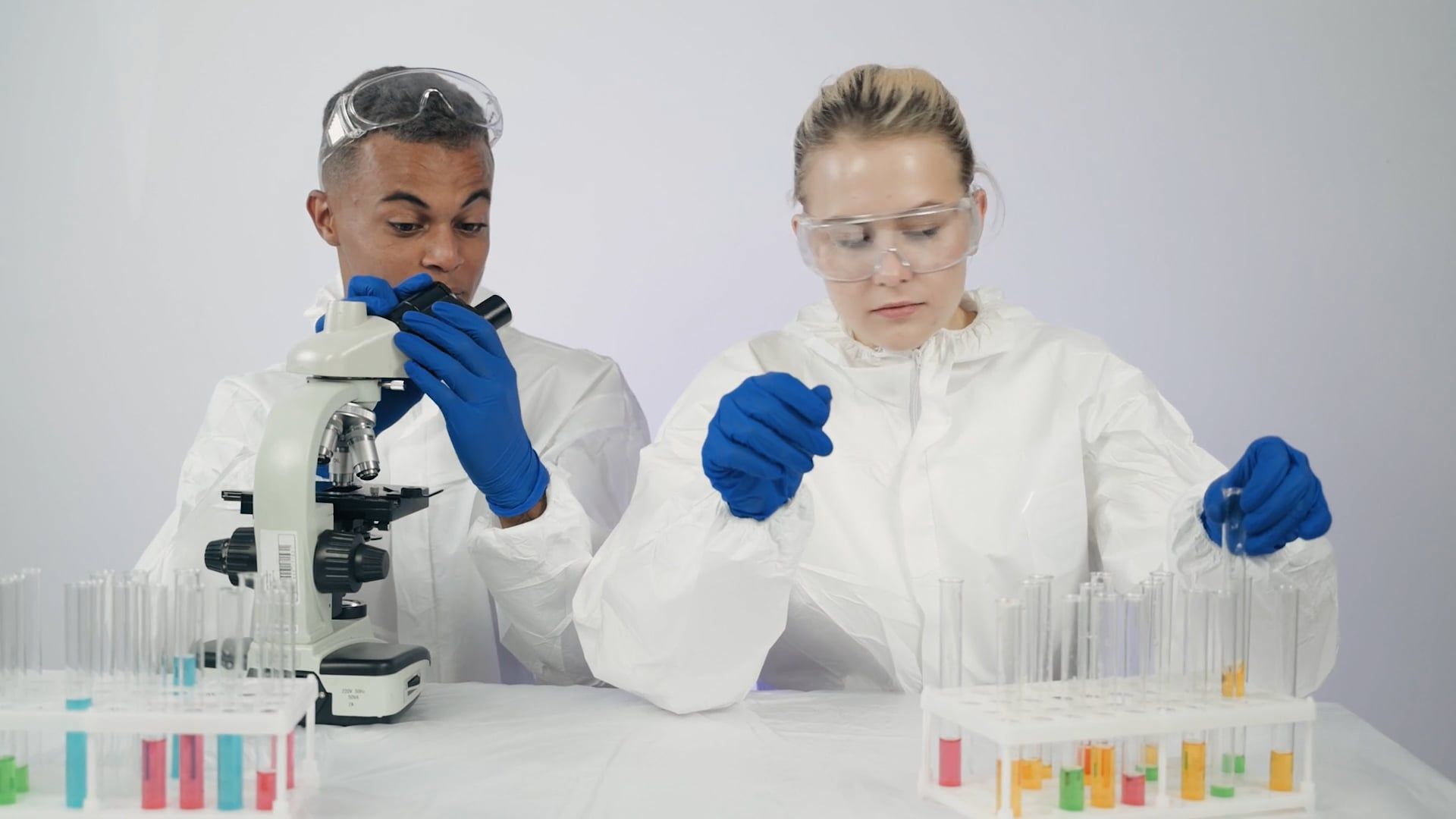 Man and Woman using Microscope Free Stock Video Footage, Royalty-Free ...