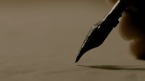 Person Writing Using a Fountain Pen