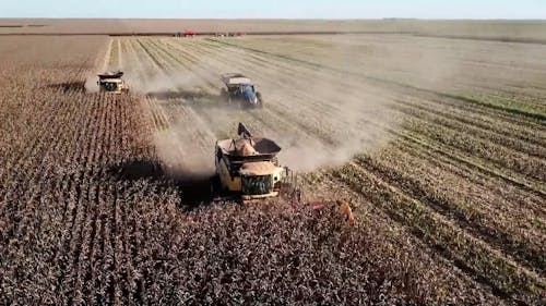 A Drone Footage of a Tractors on the Field