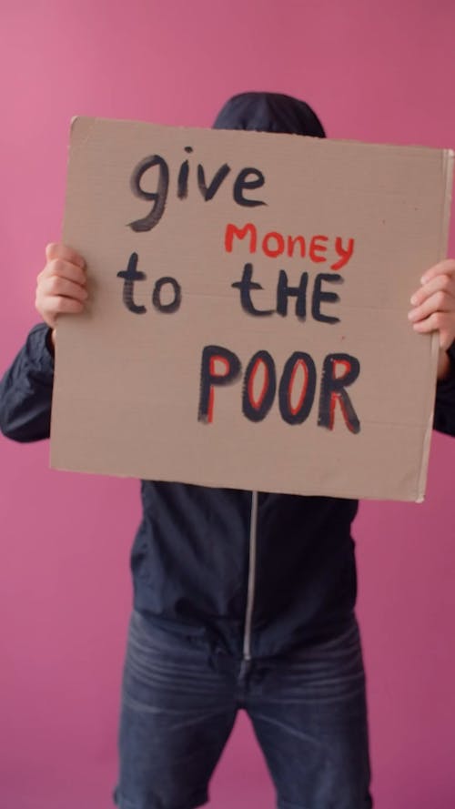 A Person in Gas Mask Holding a Placard