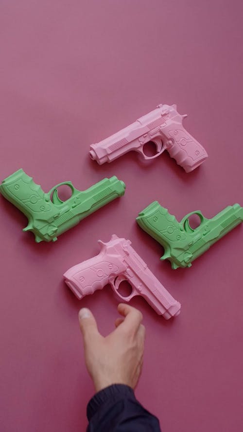 A Person Getting a Pink Gun