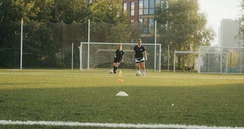 Women Training Soccer at the Field