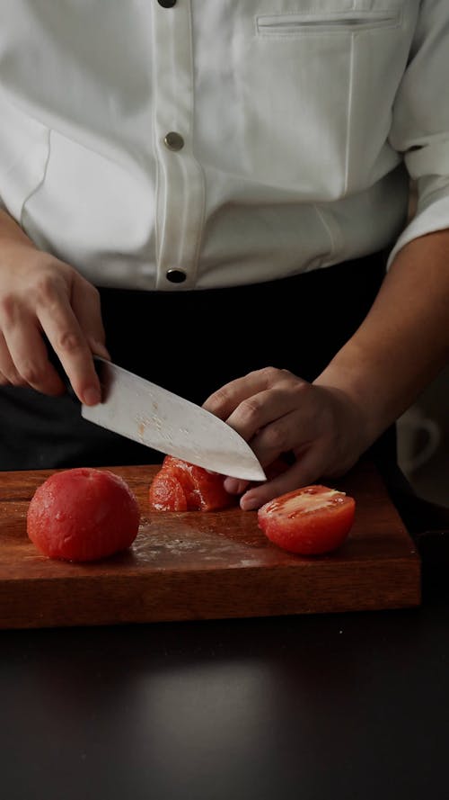 Close Up Video of a Person Slicing a Tomato