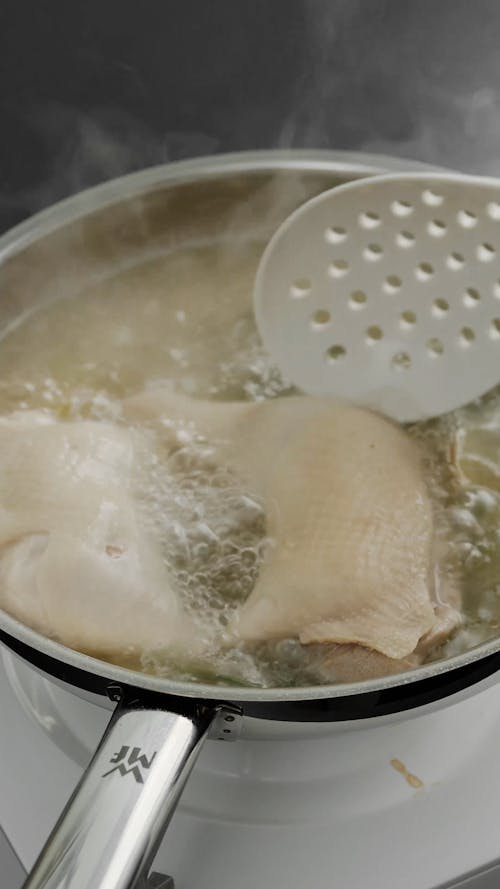 A Person Cooking Poached Chicken