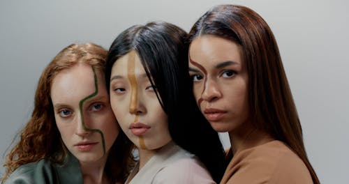 Close up of Women with Face Paint Posing Together