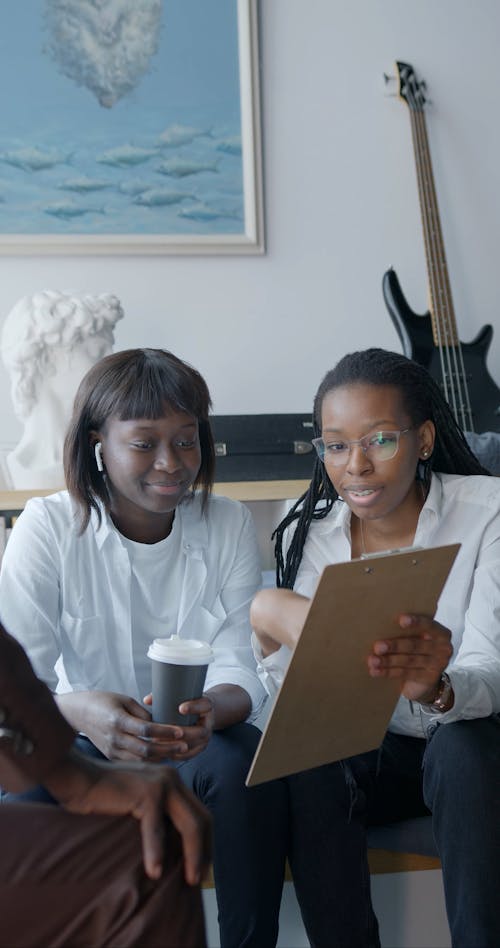 Women Looking at a Clipboard