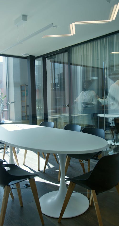 People Sitting Down on Chairs at a Conference Room