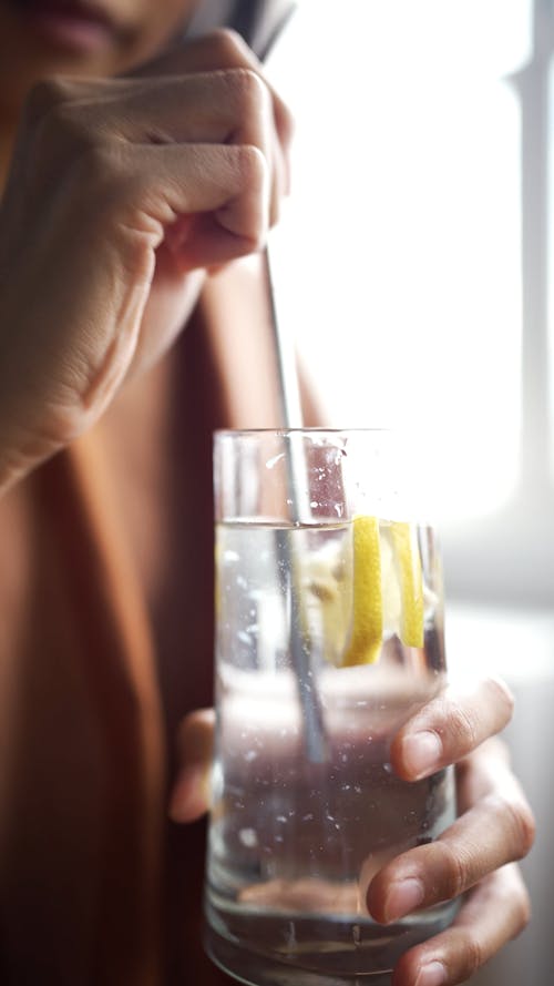 A Person Stirring a Lemon Juice