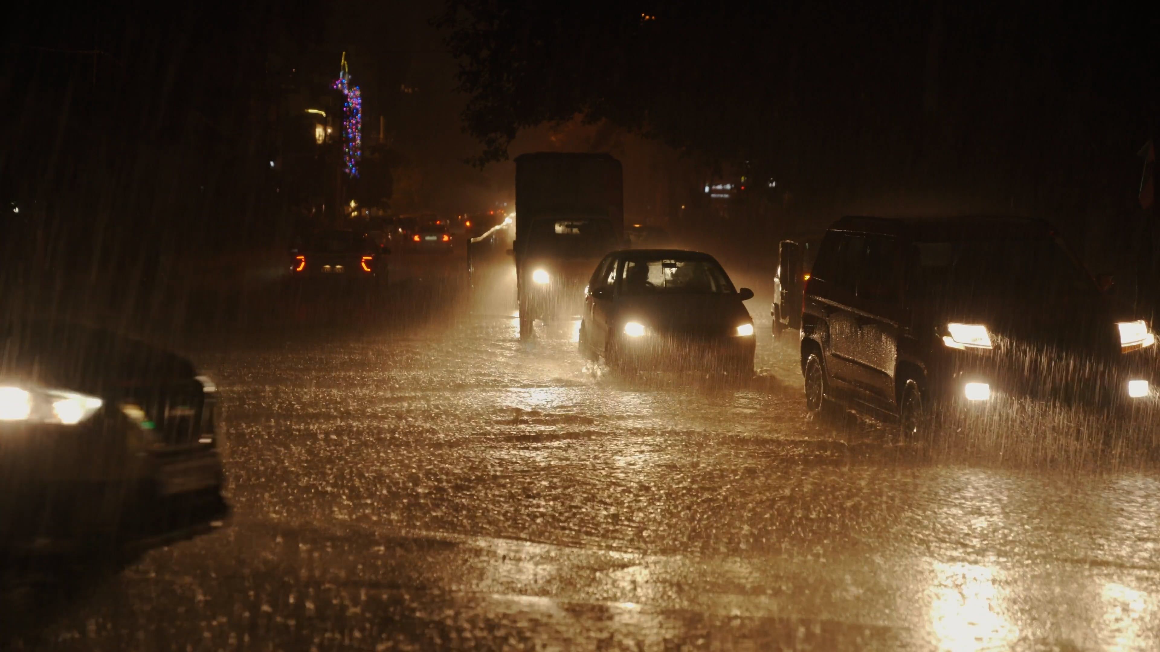 Cars drive through a flooded street at night Free Stock Video Footage ...