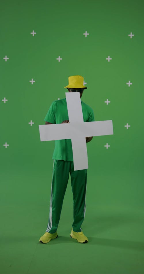 A Man Standing while Holding a Cross