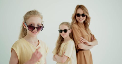 A Woman and Twin Girls Smiling and Posing at the Studio