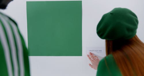 A Man and a Woman Posing in Green Outfits